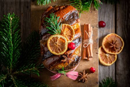 Traditionally orange gingerbread for Christmas decorated with spruce
