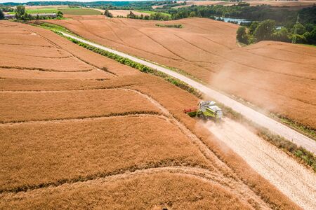 Big harvester working on field in Poland, aerial view