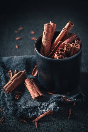 Closeup of aromatic cinnamon sticks as rustic backgroundの写真素材