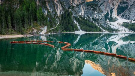 Wooden boats on Lago di Braies in Dolomites, Italyの写真素材