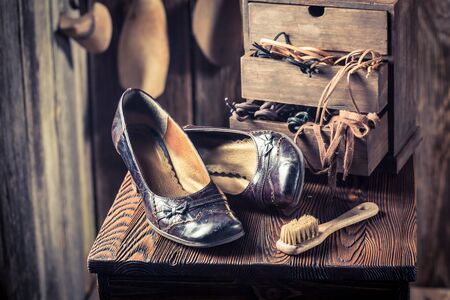 Closeup of shoemaker workshop with shoes, tools and lacesの写真素材