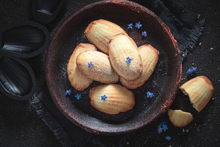 Traditionally Madeleine cookies baked in a fluted tin or mould
