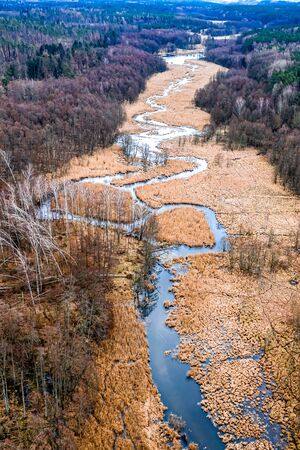 Aerial view of small river and brown swamps, Polandの写真素材