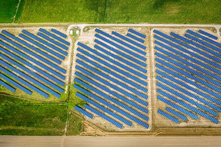 Big and blue solar panels in sunny day, aerial viewの写真素材