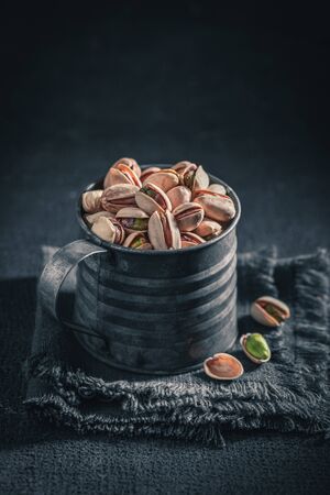 Tasty pistachios in a rustic metal boxの写真素材