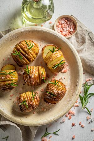 Tasty baked potatoes made with salt and rosemaryの写真素材