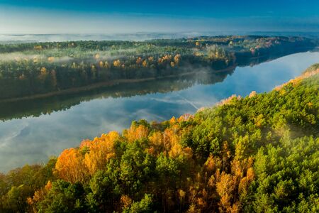 Crystal clear lake with chemtrail reflection, aerial view