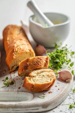 Tasty and homemade garlic bread with salt and herbsの写真素材