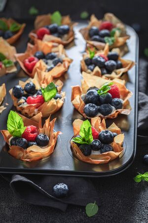 Tasty phyllo cups made of berry fruits and creamの写真素材