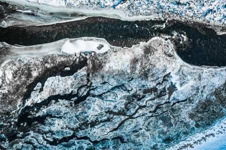 Aerial view of melting ice on river in winter
