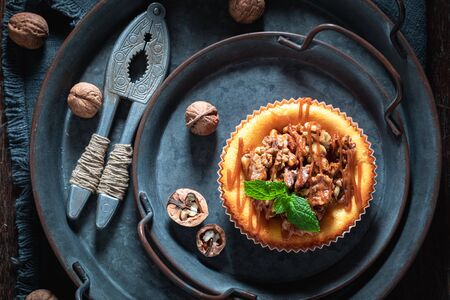 Sweet and yummy walnut cheesecake on dark plate