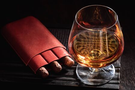 Aged cognac and cigar on old humidorの写真素材