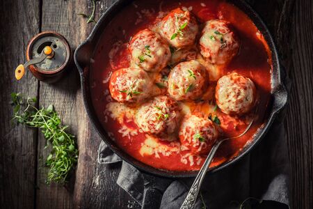 Closeup of spicy meatballs with cheese and tomato sauceの写真素材