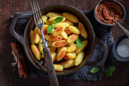 Tasty potato dumplings with cinnamon, sugar and mint leavesの写真素材