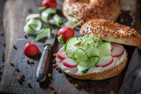 Homemade bagel with radish and cottage cheese for quick lunchの写真素材