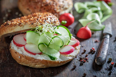 Healthy bagel with cottage cheese and cucumber for fresh breakfastの写真素材