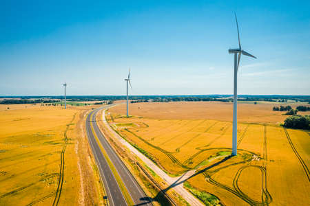 Wind turbines near highway in Poland, aerial view, Europe