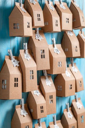 Handmade Christmas Advent Calendar as small house with a numberon blue wooden backgroundの写真素材