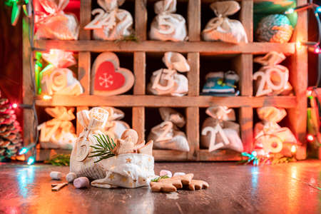 Original Advent Calendar for Christmas made of bags and stringon dark backgroundの写真素材