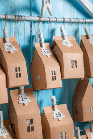Cute Christmas Advent Calendar made of cardboard and stringon blue wooden backgroundの写真素材