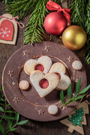 Sweet stained glass cookies in the shape of a heart on wooden tableの写真素材