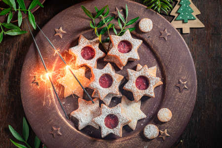 Handmade stained glass cookies in the shape of a star on wooden table