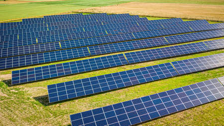 Aerial view of solar panels on green field in Poland, Europeの写真素材