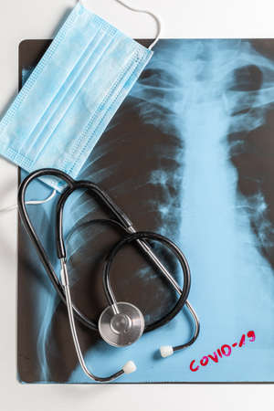 X-ray of the lungs, protective mask and stethoscope on white backgroundの写真素材