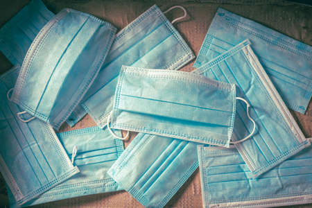 Old suitcase full of disposable masks as travel restrictions. Covid-19 restriction.