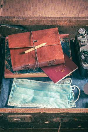 Disposable mask in suitcase as travel restrictions. Covid-19 restriction. Trip preparation.の写真素材