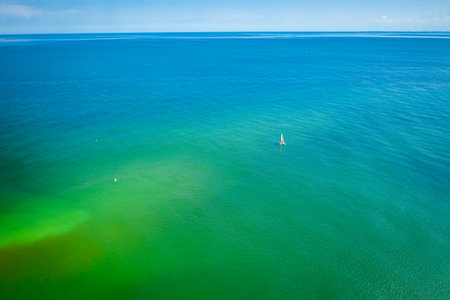Big and wide Baltic Sea and lonely one boat, aerial view, Polandの写真素材