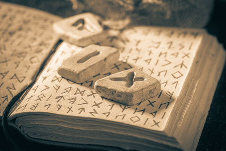 Closeup of extraordinary runic stones made of Celtic language and old bookの写真素材