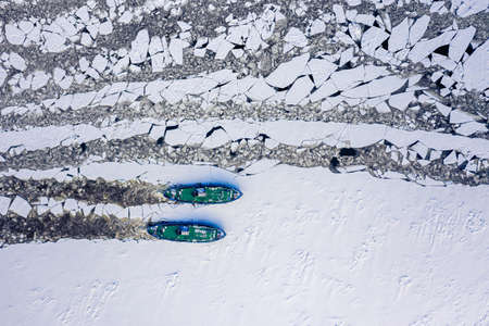 Two icebreakers floating on Vistula crush the ice, 2020-02-18, Poland, aerial view