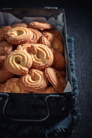 Homemade danish cookies as crunchy and vanilla snack on dark table