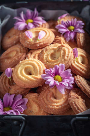 Sweet round butter cookies in an old metal box on dark tableの写真素材