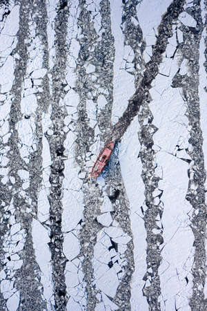Breaking ice on Vistula river by Icebreakers, Poland, aerial view of Poland