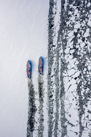 Icebreakers on Vistula river near Plock breaking the ice, Poland, aerial view of nature