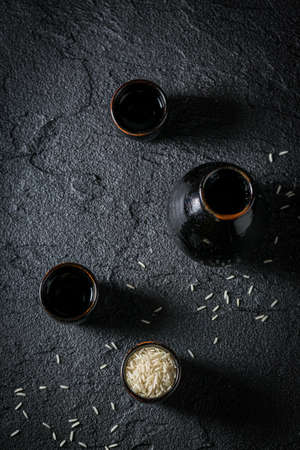 Black ceramics and rice to make sake. Japanese cuisine.の写真素材