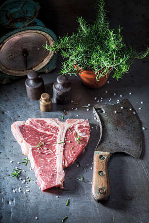 Red and raw t-bone steak on old metal table. Raw red steak for roasted.の写真素材
