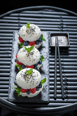 Delicious sush burger with blueberries and raspberries as Japanese dessert. Japanese cuisine.