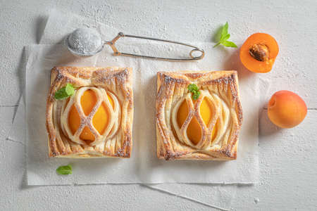 Homemade puff pastry with peaches and mint. Unique yummy cake. French cuisine.の写真素材