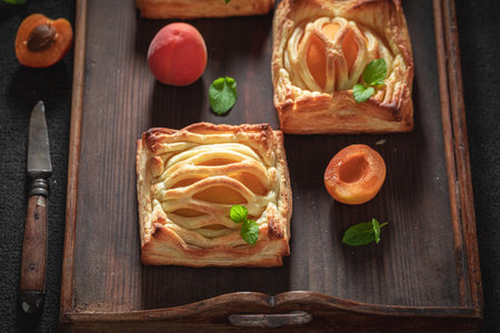 Homemade puff pastry with sugar and peaches. Unique yummy cake. French cuisine.の写真素材