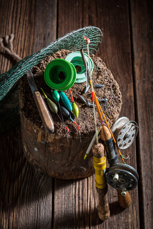 Retro stuff for angler with floats and hooks. Fishing equipment. Old wooden workshop fisherman.の写真素材