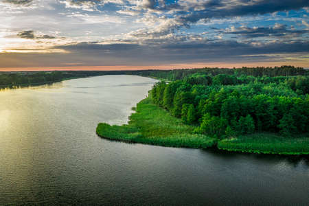 Lonely boat on lake at sunset. Aerial view of nature in Poland, Europeの写真素材