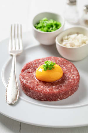 Spicy beef tartare with gherkin and chives. Full of protein. Source of protein and minerals.の写真素材