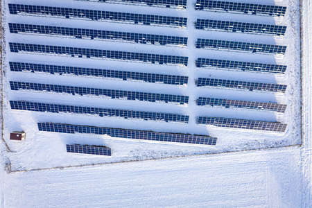 Photovoltaic farm on snowy field. Alternative energy in Poland, Europeの写真素材