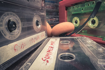 Plastic cassette and old player. Player with spinning green audio cassette.の写真素材