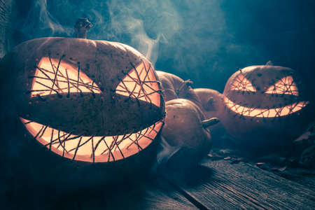 Scary and mysterious Jack-o-lantern with blue moonlight. Background with copy space for Halloween.