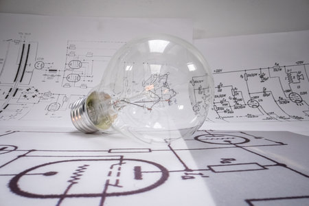 Closeup of light bulb with cables, fuses, diagrams. Old fashioned crafts.の写真素材