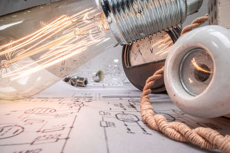 Edison light bulb with fuses, cables and diagrams. Old fashioned crafts.の写真素材
